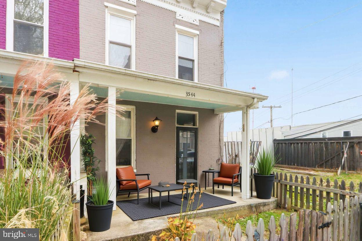 a view of a patio with a table and chairs