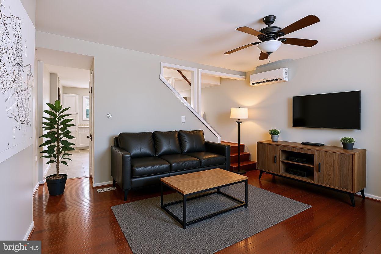 3544 Ash Street Baltimore, MD 21211 - Photo 5 of 17 a living room with furniture flat screen tv and a potted plant