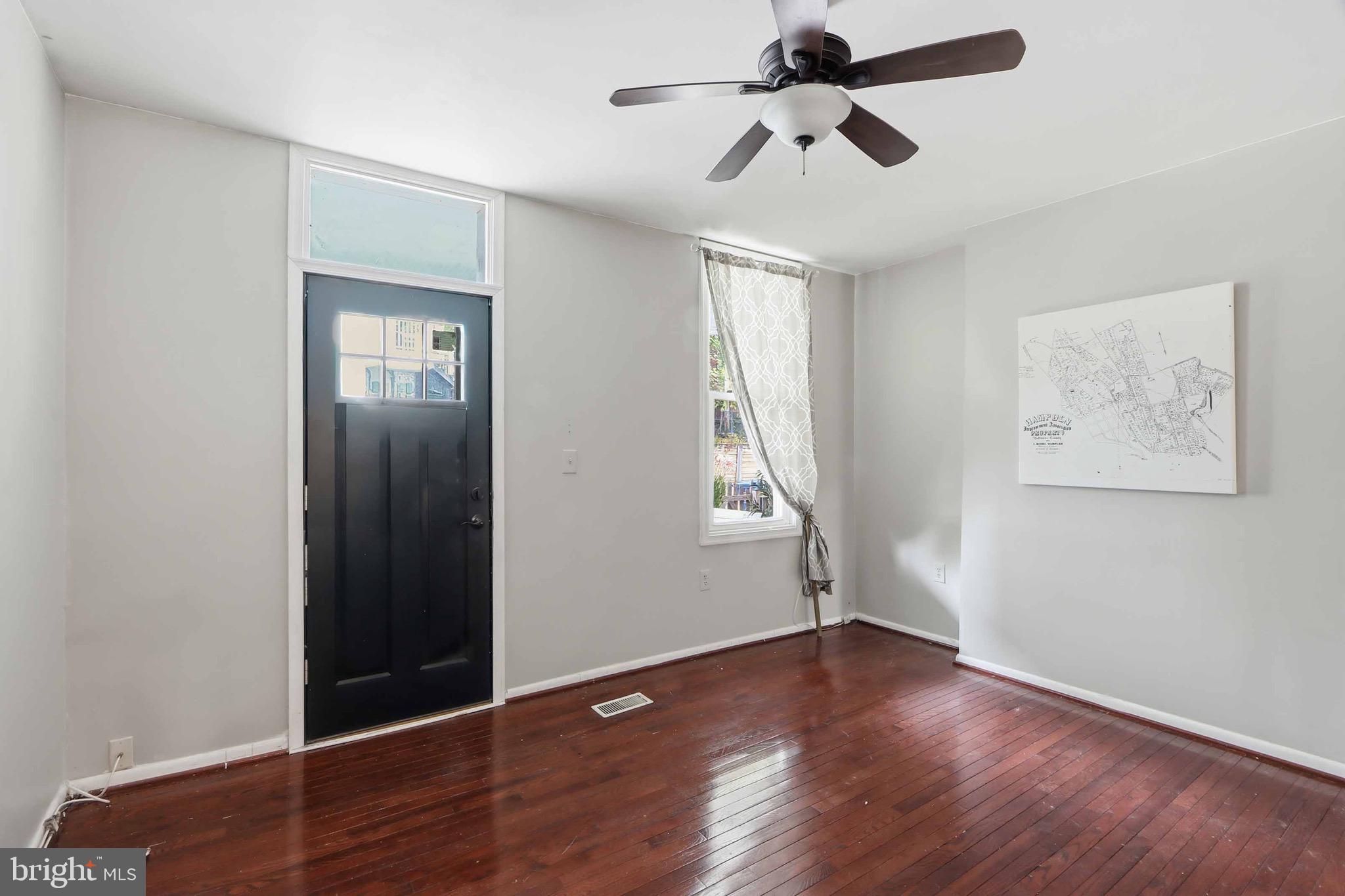 3544 Ash Street Baltimore, MD 21211 - Photo 6 of 17 wooden floor in an empty room with a window