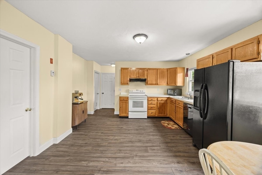 35 Hazel Street, Unit B Attleboro, MA 02703 - Photo 9 of 21 a kitchen with stainless steel appliances a refrigerator and a stove top oven