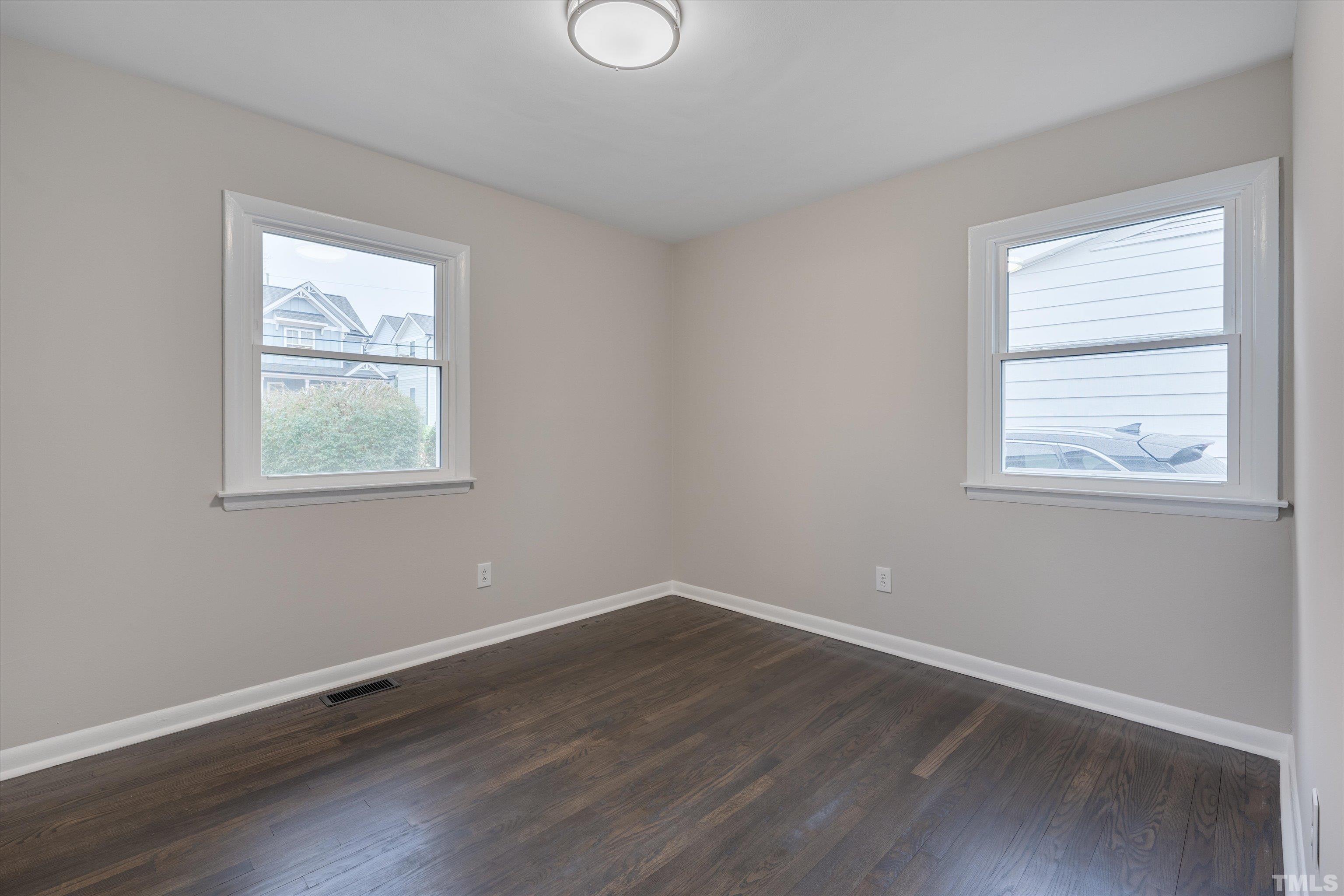711 Coleman Street Raleigh, NC 27610 - Photo 12 of 14 a view of an empty room with wooden floor and a window