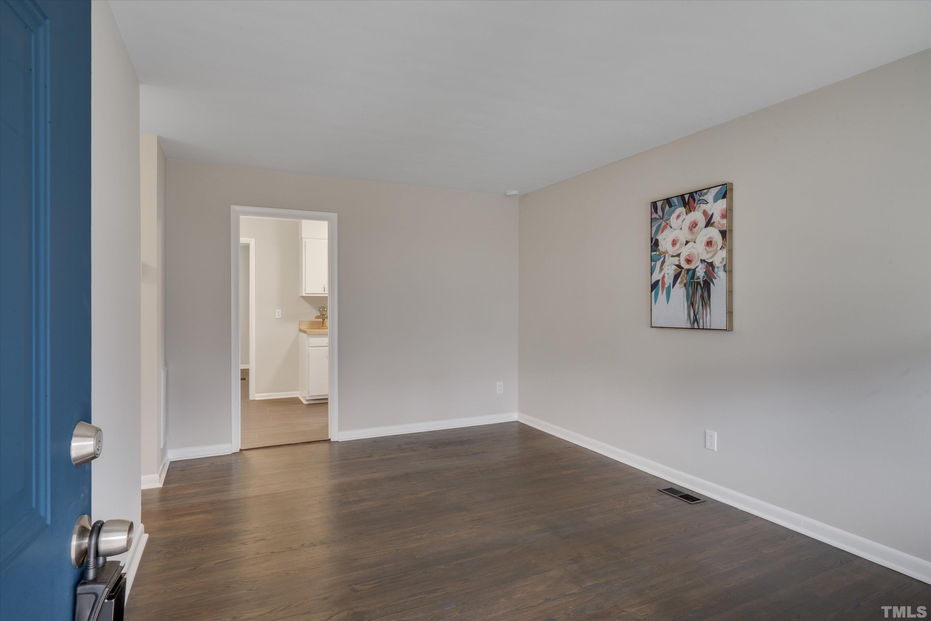 711 Coleman Street Raleigh, NC 27610 - Photo 3 of 14 an empty room with wooden floor and windows