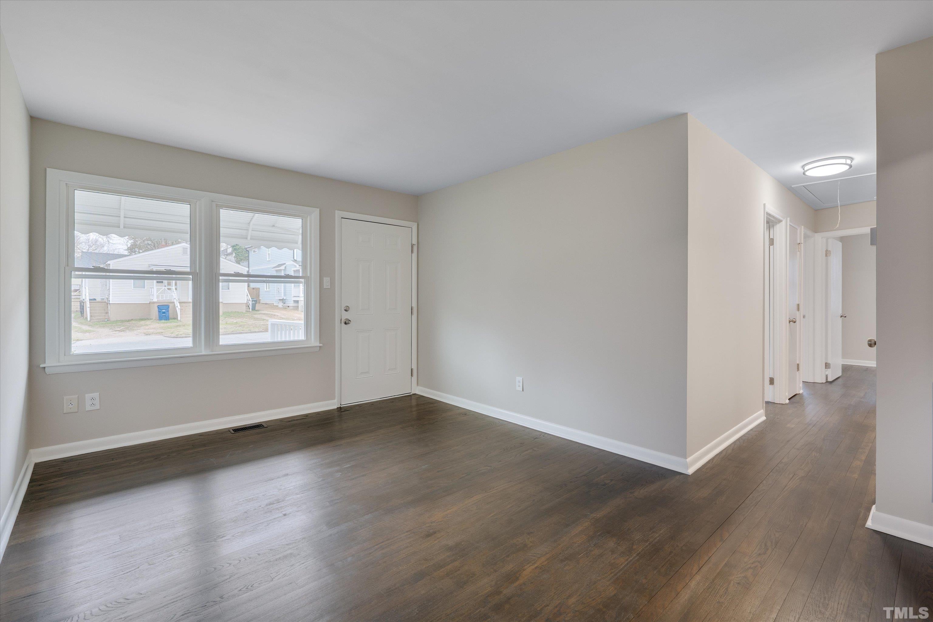 711 Coleman Street Raleigh, NC 27610 - Photo 4 of 14 a view of an empty room with wooden floor and a window