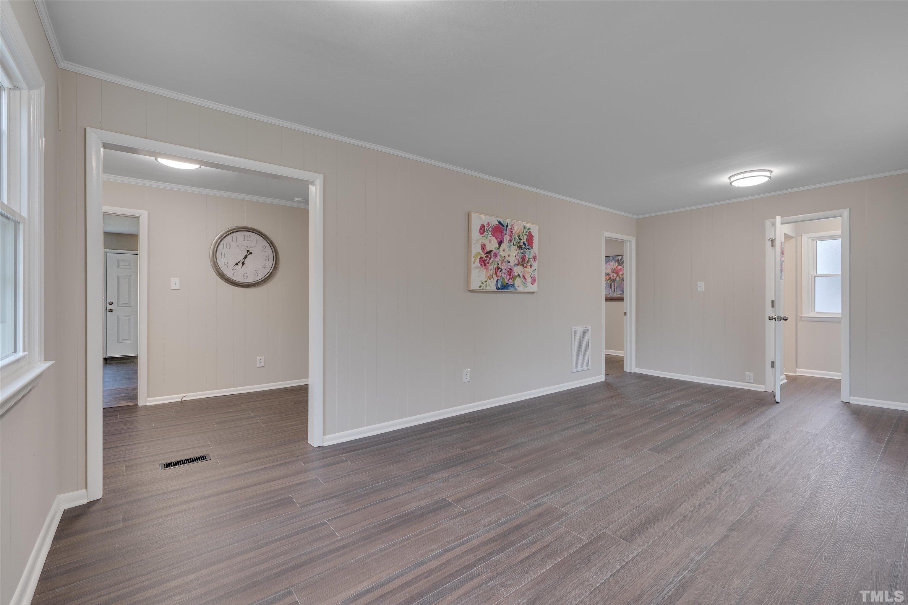 711 Coleman Street Raleigh, NC 27610 - Photo 7 of 14 a view of an empty room with wooden floor
