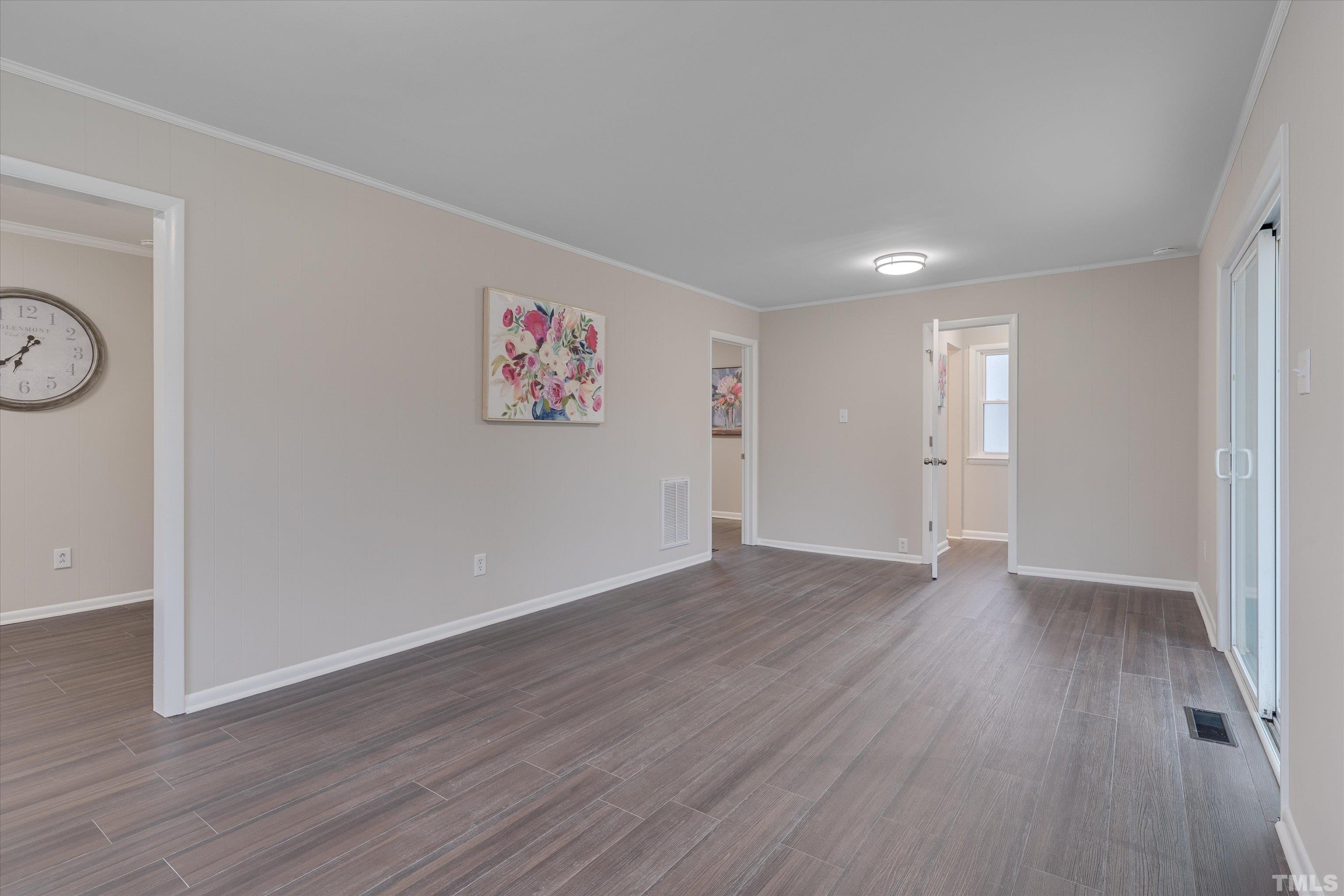 711 Coleman Street Raleigh, NC 27610 - Photo 8 of 14 a view of an empty room with wooden floor