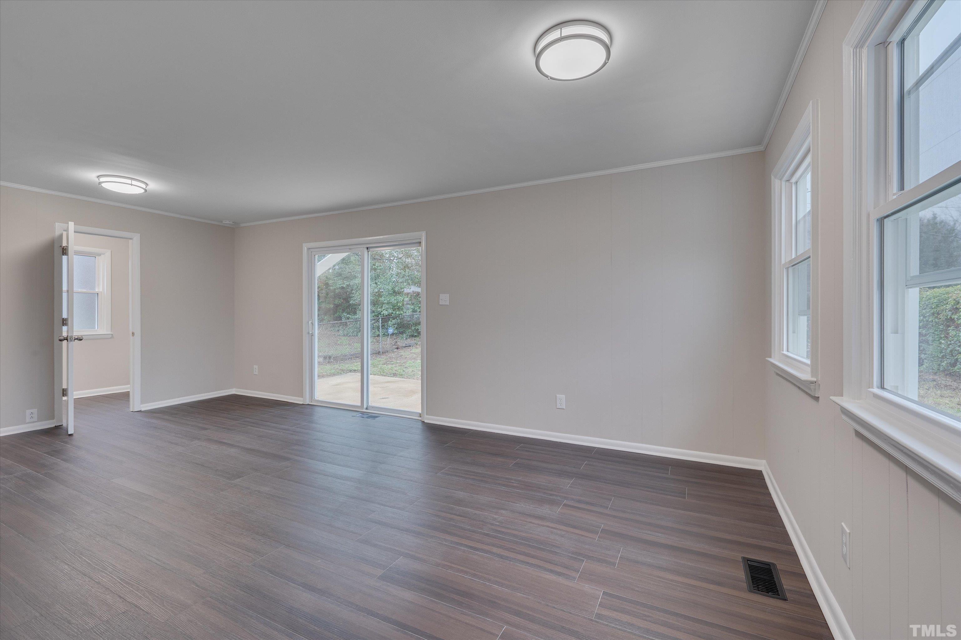 711 Coleman Street Raleigh, NC 27610 - Photo 9 of 14 an empty room with wooden floor and windows