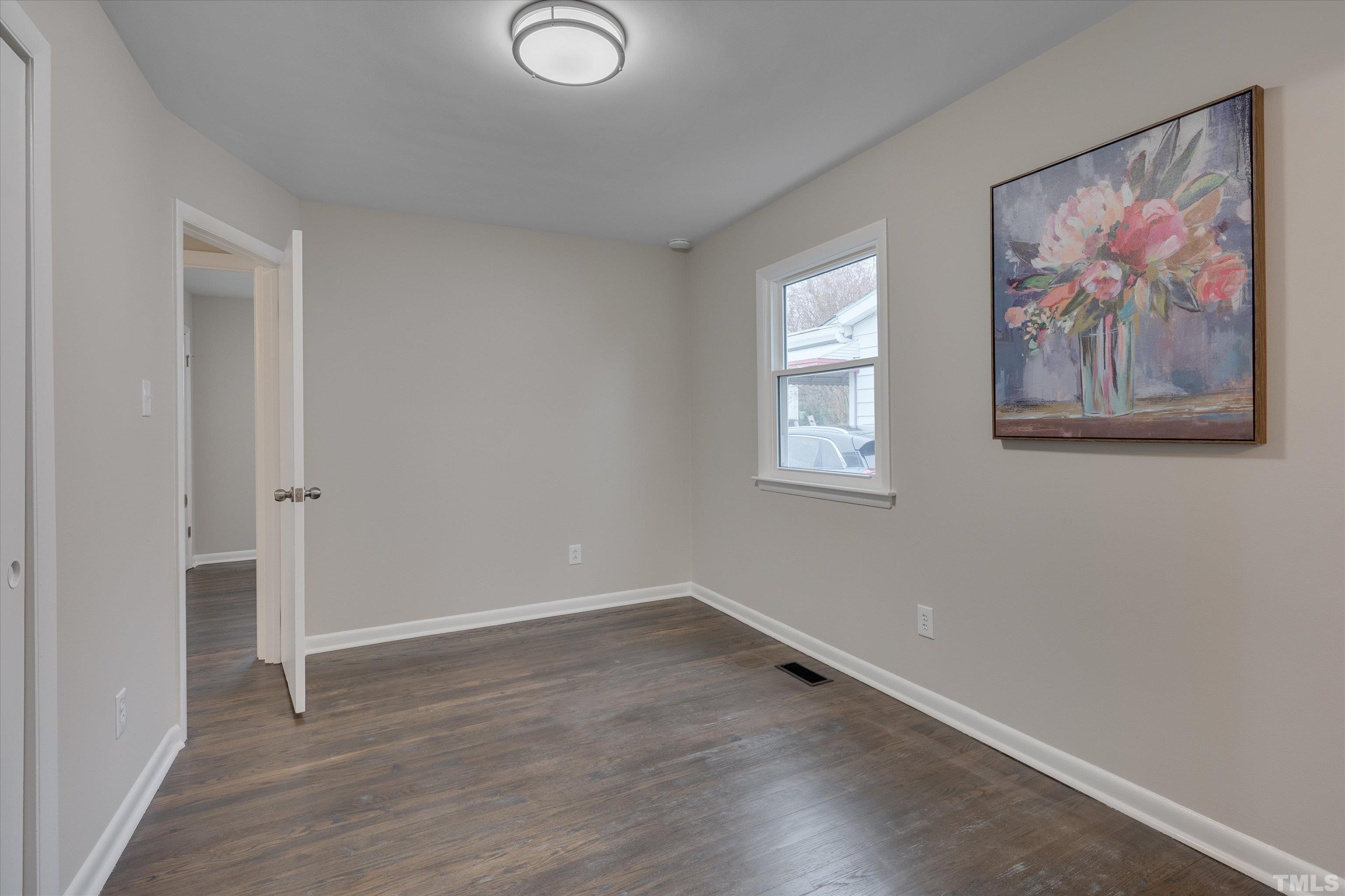 711 Coleman Street Raleigh, NC 27610 - Photo 10 of 14 an empty room with a painting on the wall
