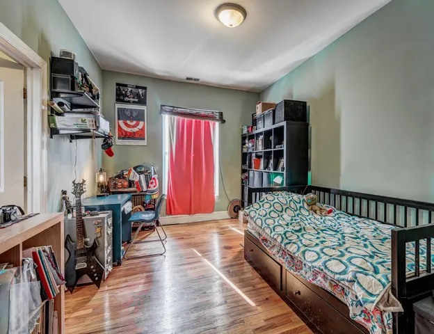 a bedroom with furniture and a book shelf
