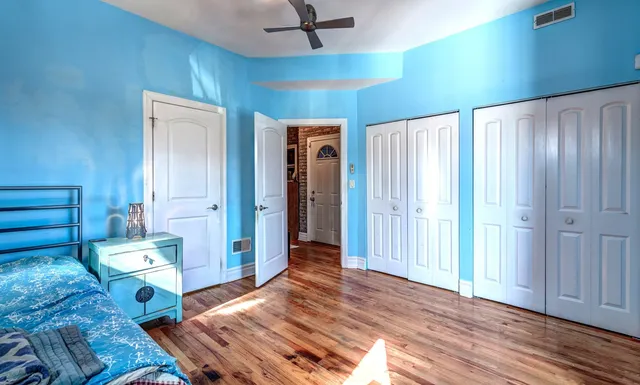 a bedroom with a bed and a chandelier