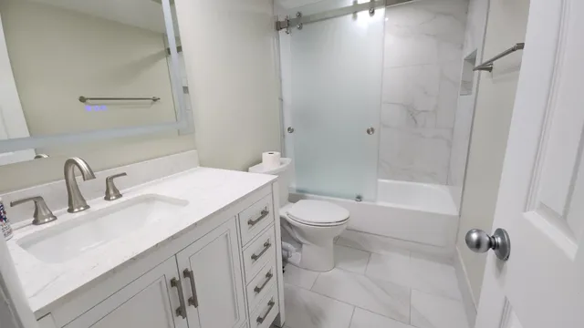 a bathroom with a sink toilet and shower
