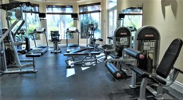 a living room with lots of gym equipment