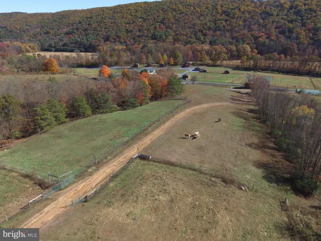 an aerial view of a house a yard and a fountain