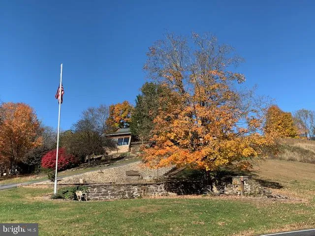 a kitchen with stainless steel appliances granite countertop a stove a sink a microwave and a refrigerator
