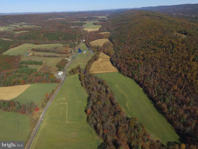 an aerial view of a house with a yard and lake view