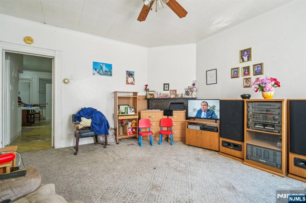 150 Martin Street Paterson, NJ 07501 - Photo 5 of 6 a living room with furniture and a chair