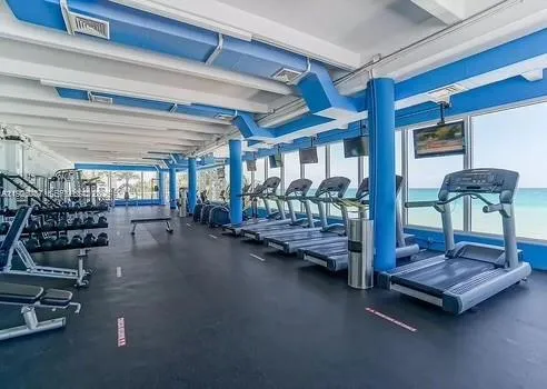 a living room with lots of furniture and gym equipment