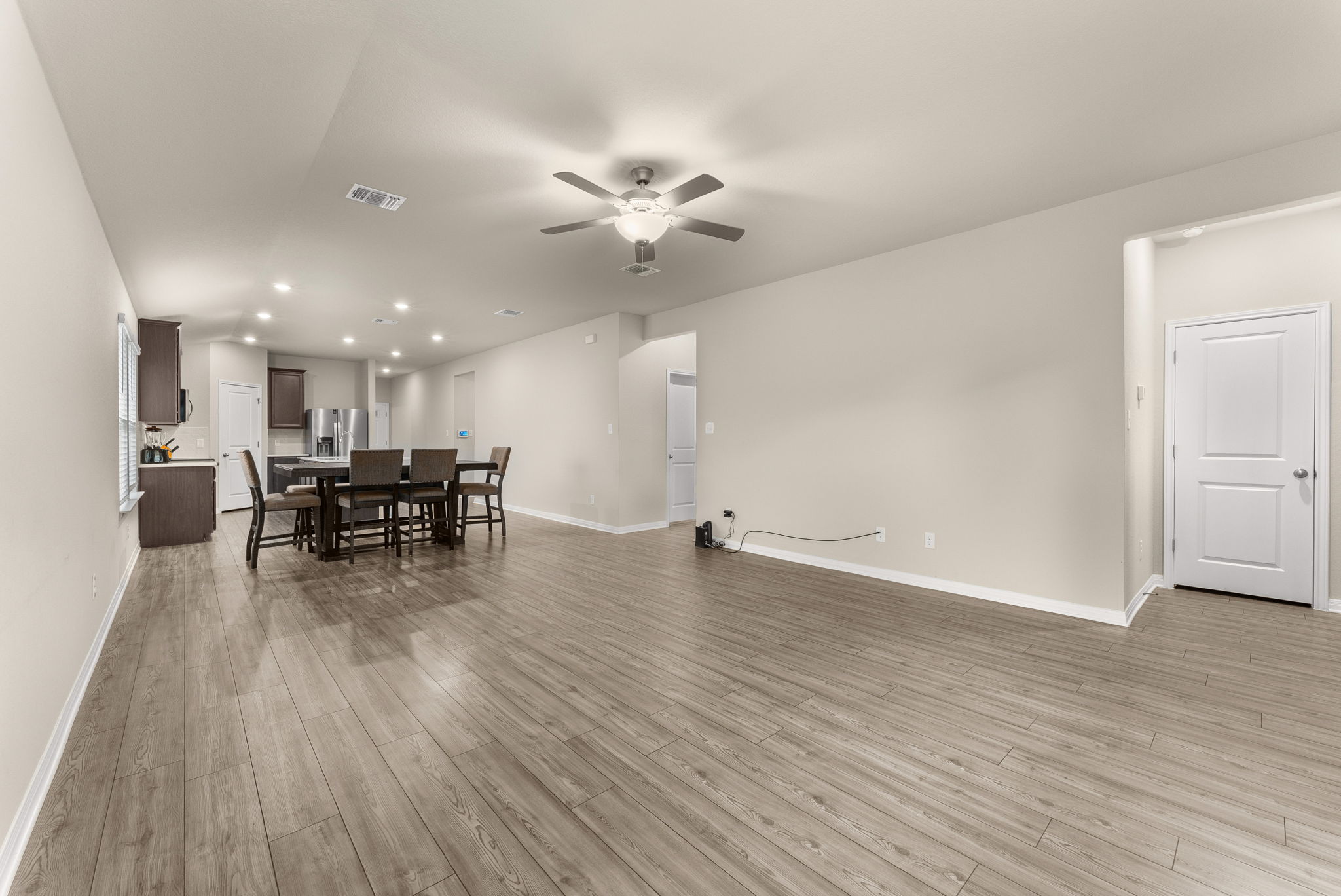 304 Giorgio Moroder Drive Hutto, TX 78634 - Photo 12 of 31 a view of a workspace with wooden floor and a ceiling fan