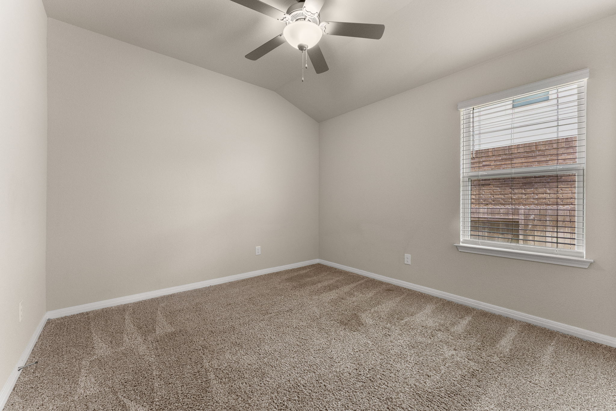 304 Giorgio Moroder Drive Hutto, TX 78634 - Photo 22 of 31 an empty room with a chandelier fan and windows