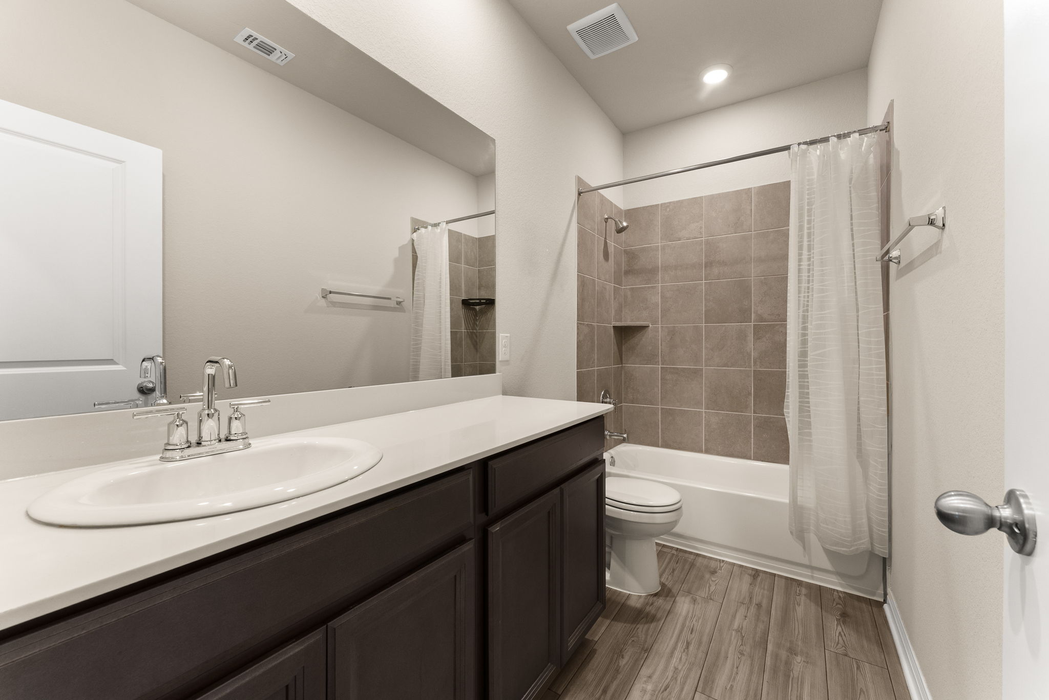 304 Giorgio Moroder Drive Hutto, TX 78634 - Photo 24 of 31 a bathroom with a sink a toilet a mirror and shower