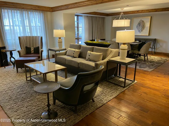 a living room with furniture a lamp and a table