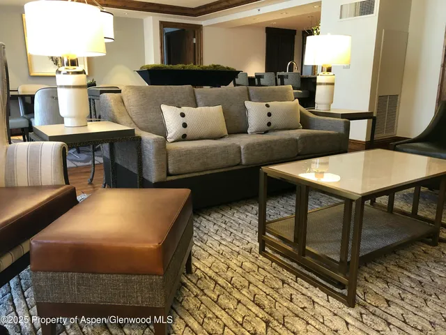 a living room with furniture and a table