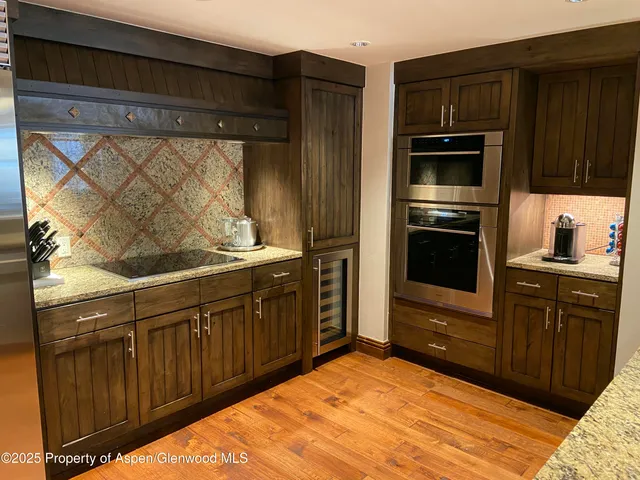 a kitchen with stainless steel appliances wooden cabinets and a sink