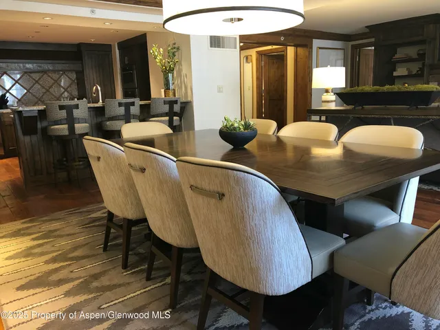 a dining room with furniture and wooden floor