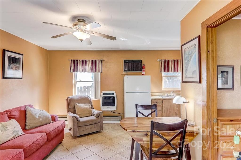1555 Soco Road, Unit 3 Maggie Valley, NC 28751 - Photo 14 of 40 a living room with furniture and a chandelier