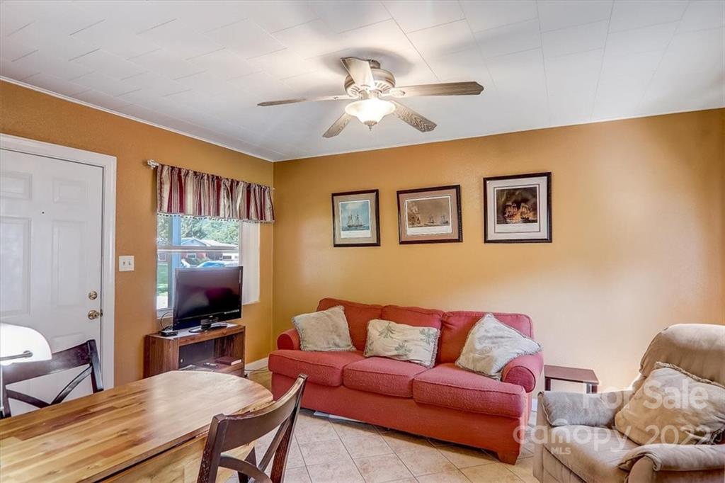 1555 Soco Road, Unit 3 Maggie Valley, NC 28751 - Photo 16 of 40 a living room with furniture and a flat screen tv