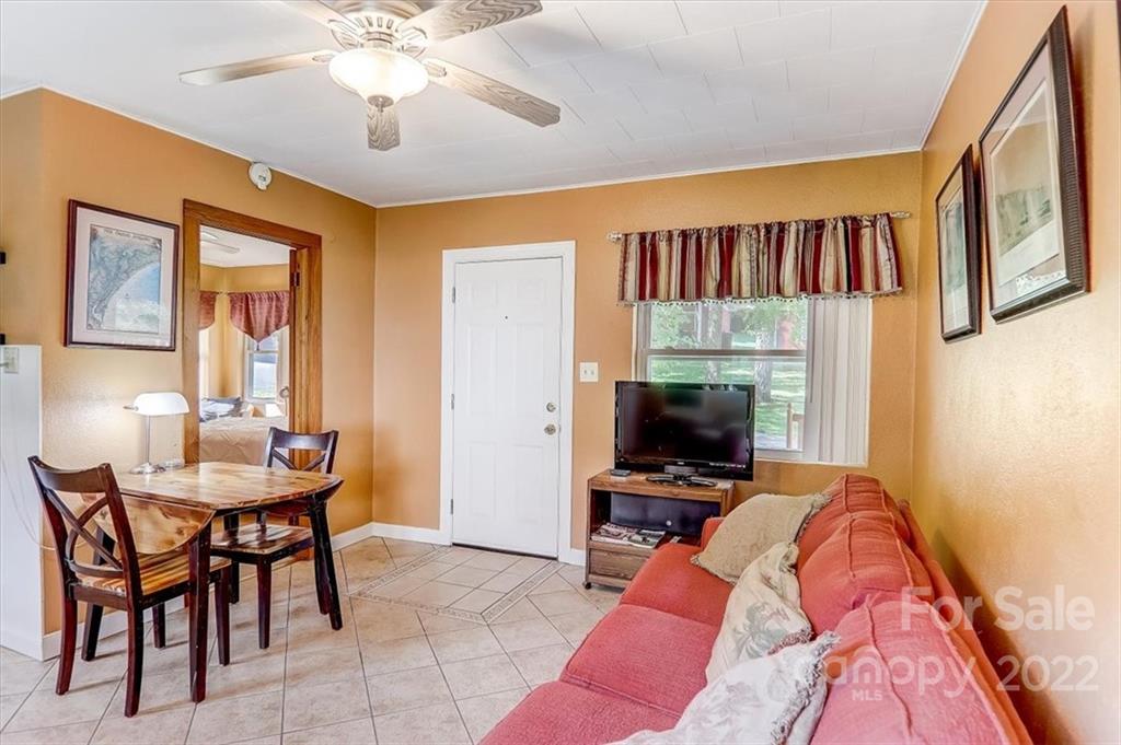 1555 Soco Road, Unit 3 Maggie Valley, NC 28751 - Photo 17 of 40 a view of a livingroom with furniture and a flat screen tv