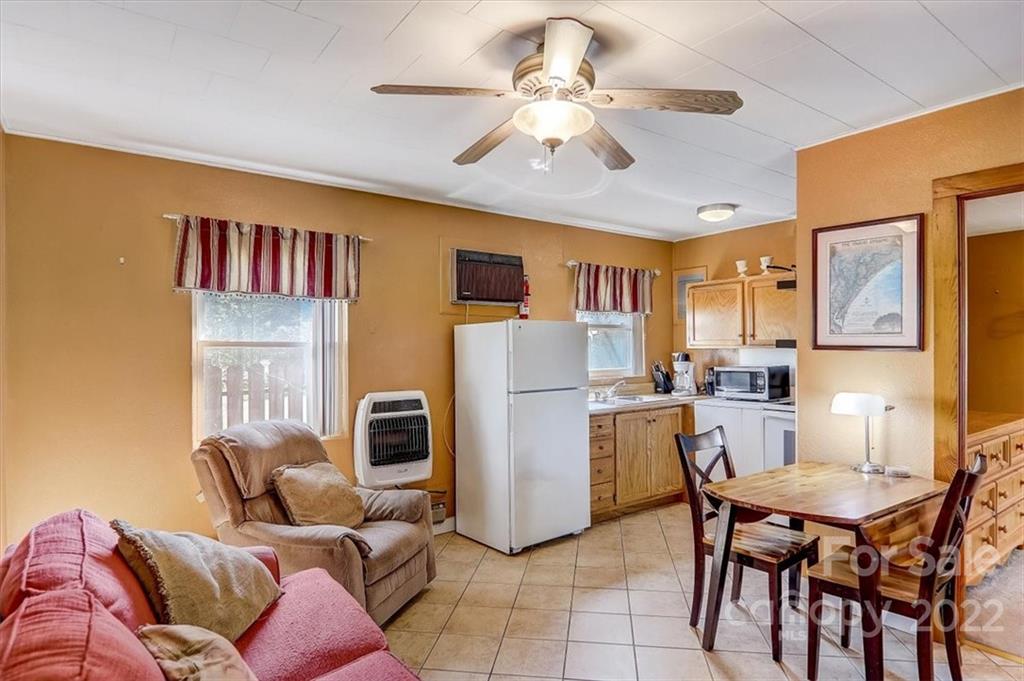 1555 Soco Road, Unit 3 Maggie Valley, NC 28751 - Photo 18 of 40 a living room with furniture and a chandelier