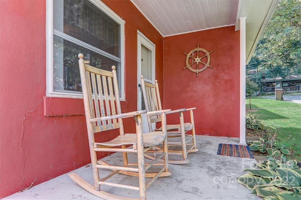 1555 Soco Road, Unit 3 Maggie Valley, NC 28751 - Photo 2 of 40 a chairs and table in a backyard