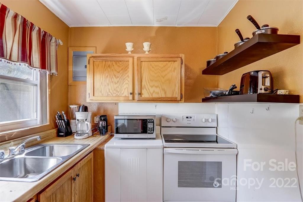 1555 Soco Road, Unit 3 Maggie Valley, NC 28751 - Photo 21 of 40 a kitchen with a stove and a sink