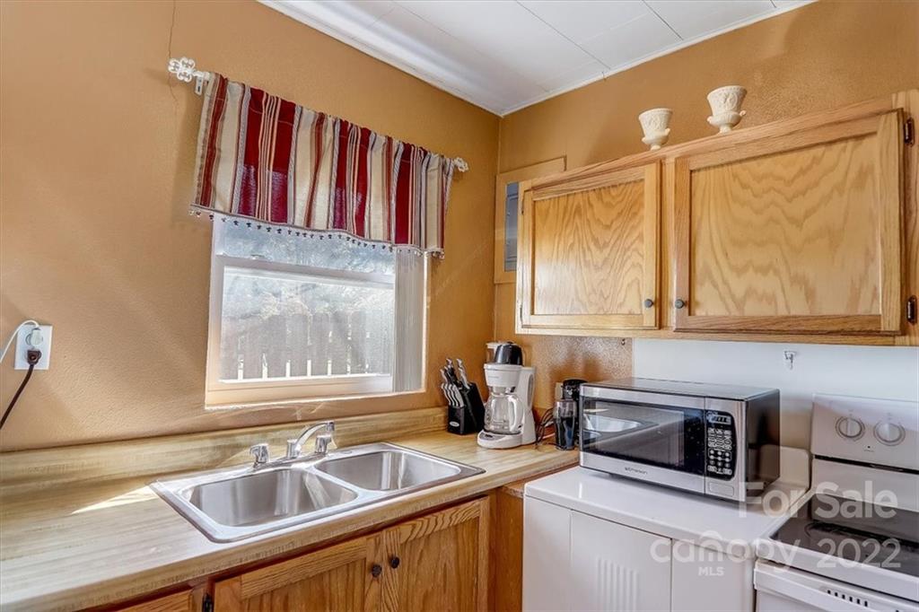 1555 Soco Road, Unit 3 Maggie Valley, NC 28751 - Photo 22 of 40 a kitchen with a sink cabinets and a wooden floor