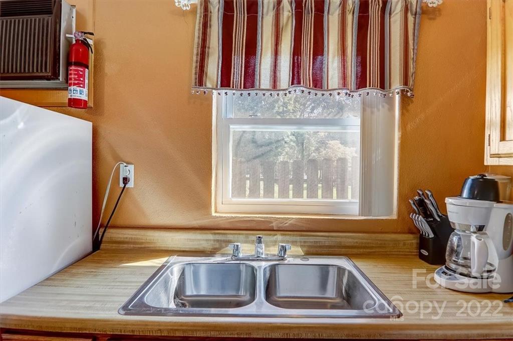 1555 Soco Road, Unit 3 Maggie Valley, NC 28751 - Photo 25 of 40 a view of kitchen with granite countertop a sink and a window