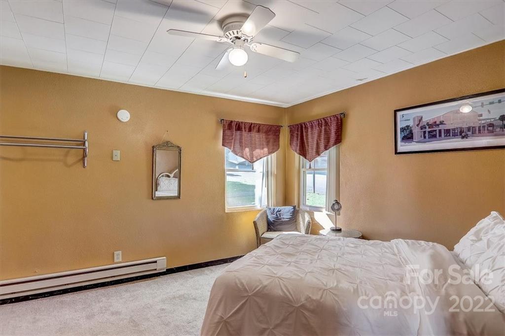 1555 Soco Road, Unit 3 Maggie Valley, NC 28751 - Photo 26 of 40 a bedroom with a bed and a chandelier