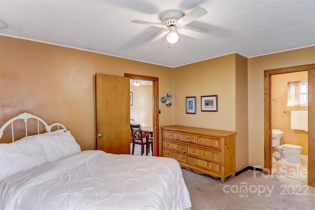 1555 Soco Road, Unit 3 Maggie Valley, NC 28751 - Photo 28 of 40 a bedroom with a bed dresser and a window