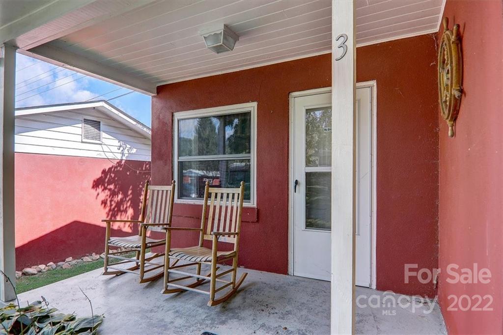 1555 Soco Road, Unit 3 Maggie Valley, NC 28751 - Photo 3 of 40 a balcony with table and chairs