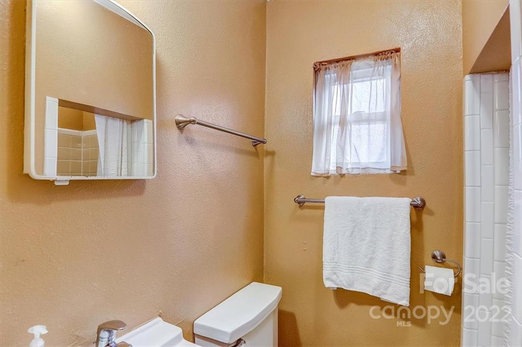 1555 Soco Road, Unit 3 Maggie Valley, NC 28751 - Photo 31 of 40 a bathroom with a sink and a mirror