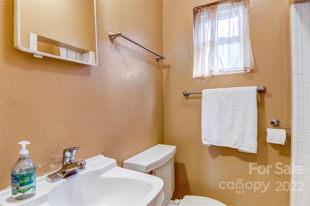 1555 Soco Road, Unit 3 Maggie Valley, NC 28751 - Photo 32 of 40 a bathroom with a sink mirror and toilet