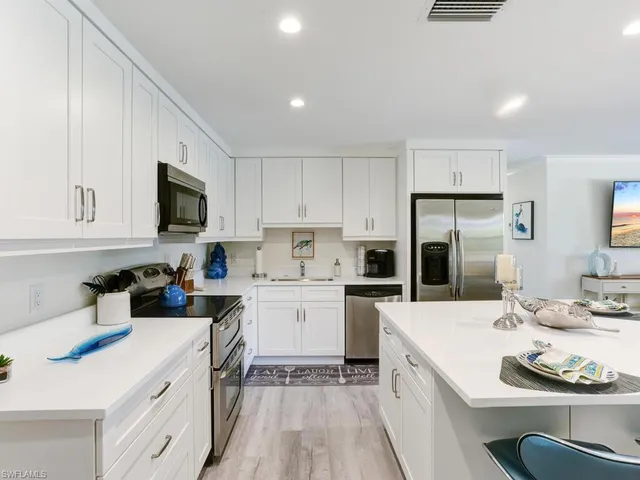 a kitchen with a sink stove and refrigerator