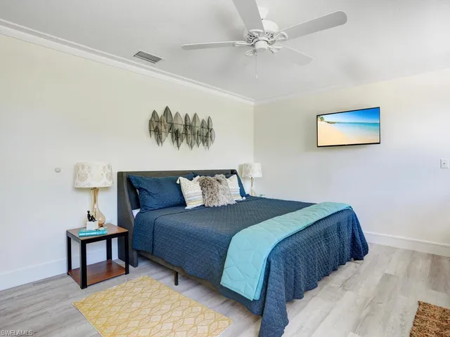 a bedroom with a bed and a painting on the wall