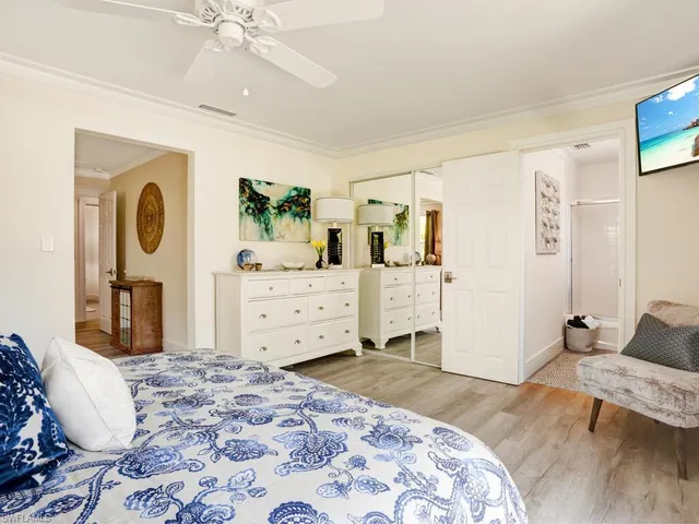 a bedroom with a large bed and a dresser