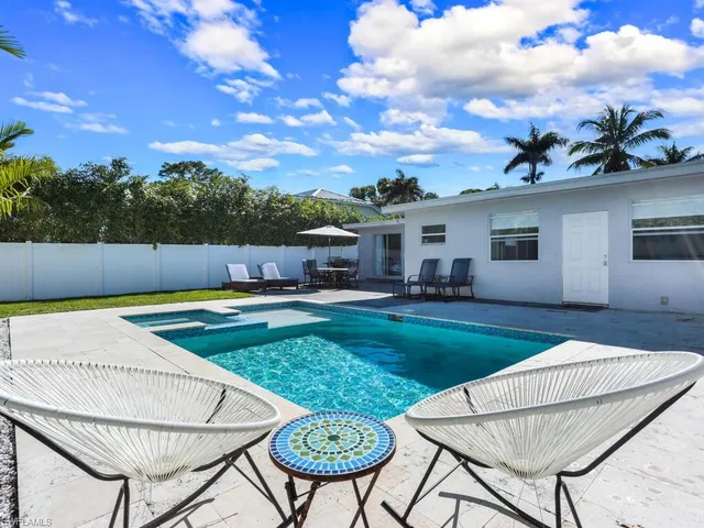 a view of a backyard with furniture