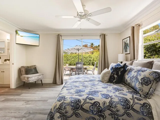 a bedroom with a large bed and a window