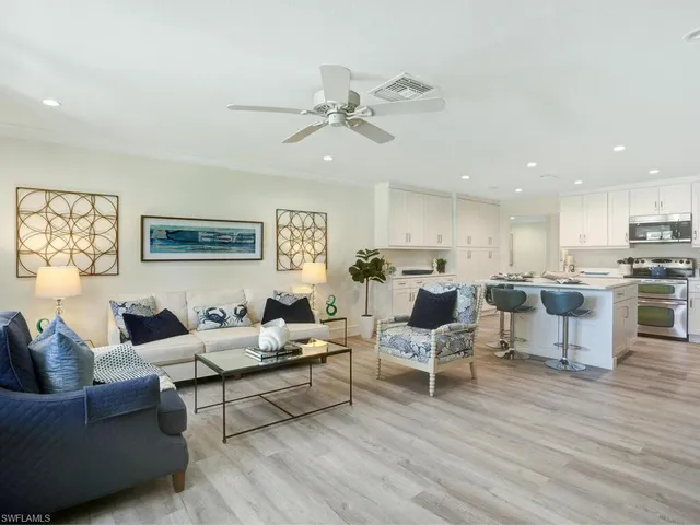 a living room with furniture and kitchen view