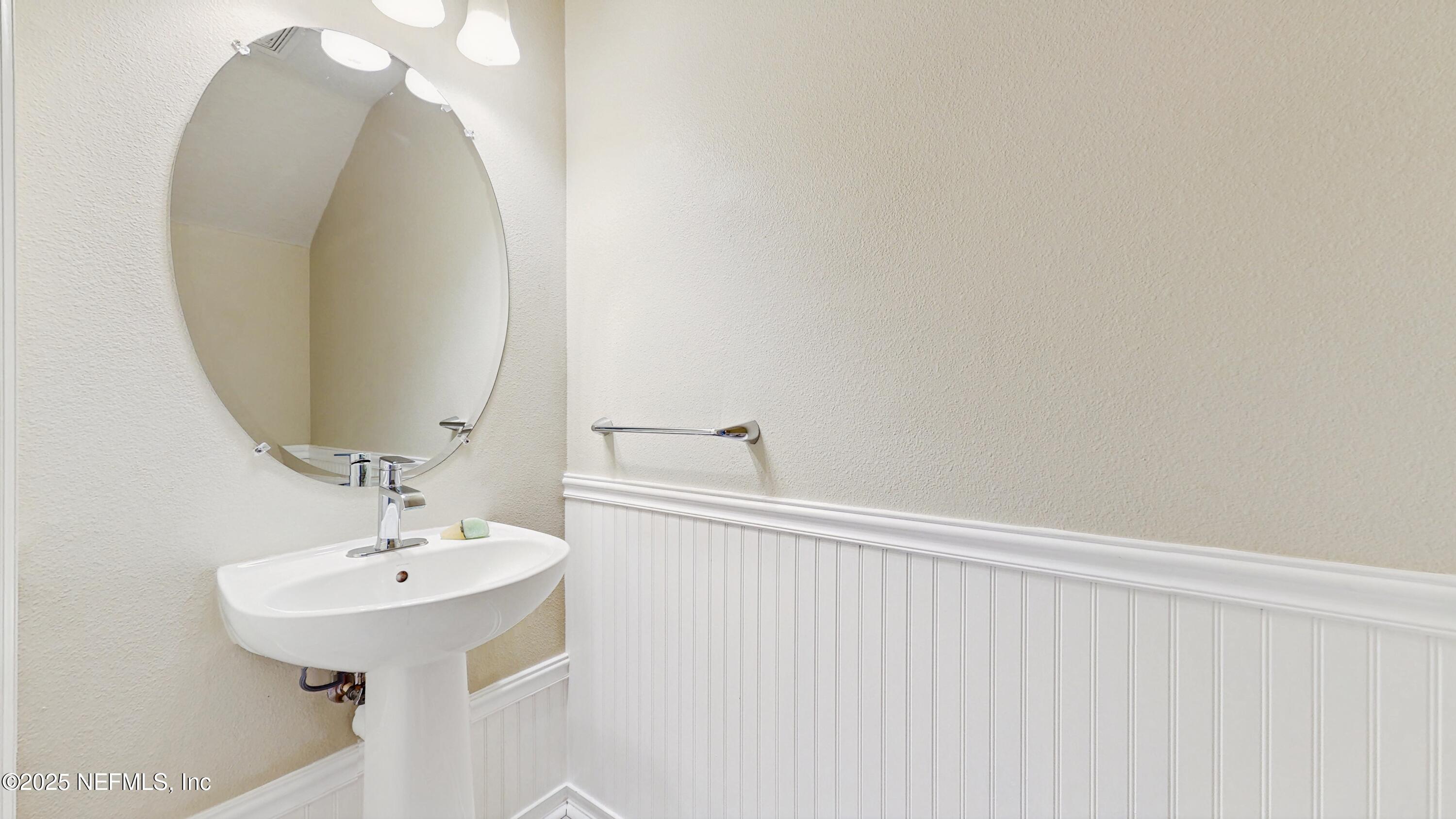 7030 Roundleaf Drive Jacksonville, FL 32258 - Photo 12 of 39 a bathroom with a sink and a mirror