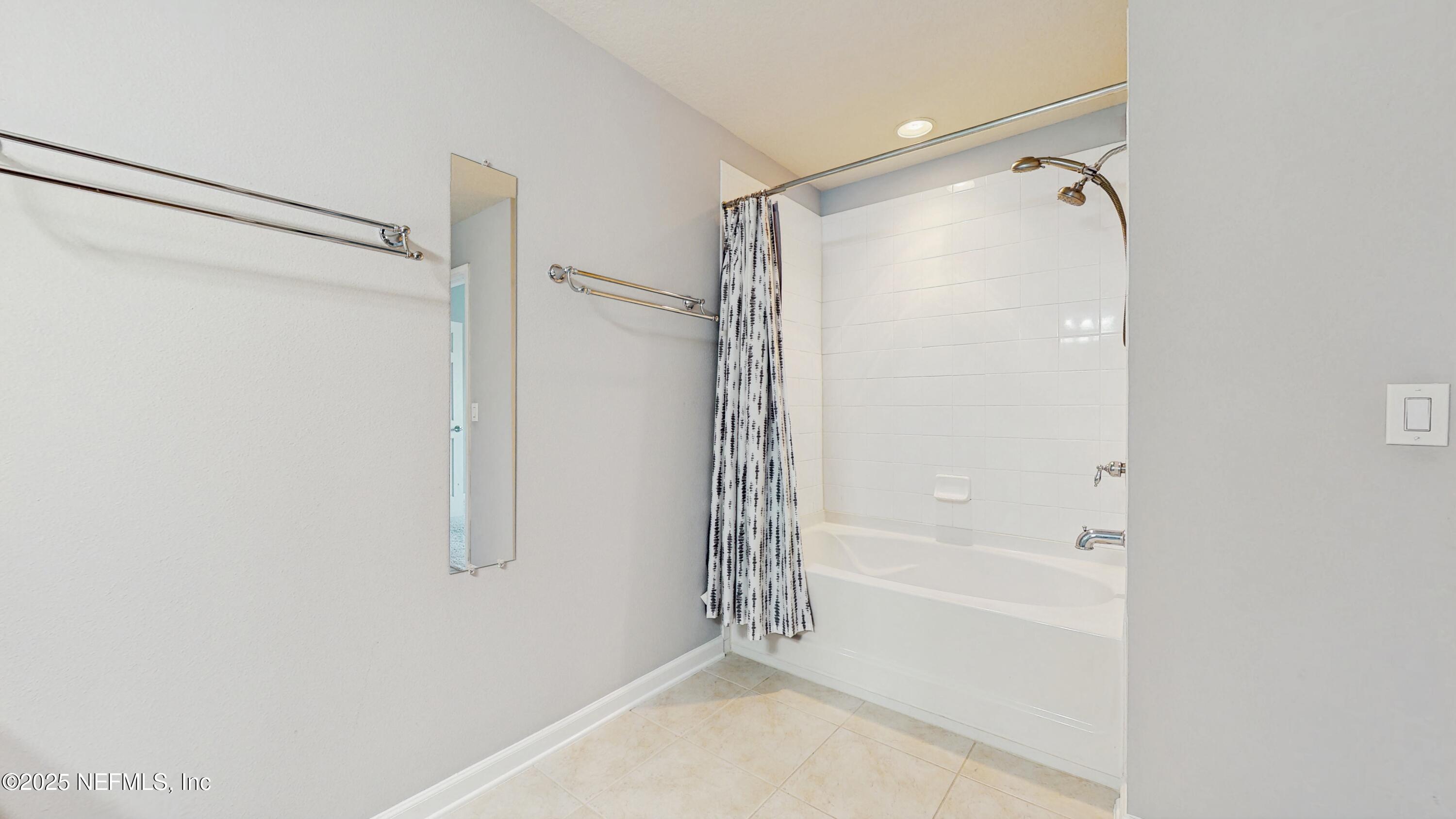 7030 Roundleaf Drive Jacksonville, FL 32258 - Photo 13 of 39 a bathroom with a shower and a bath tub