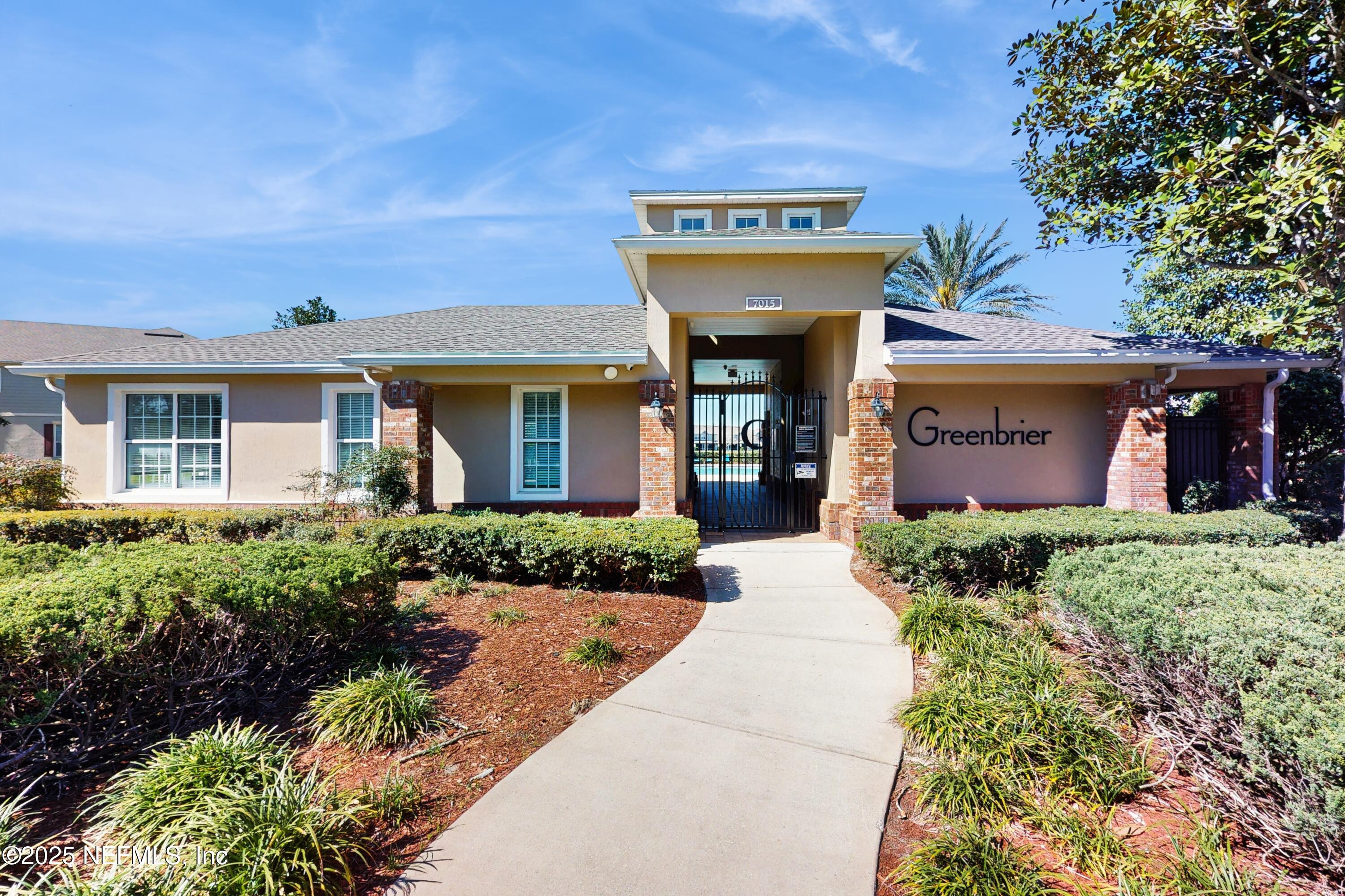 7030 Roundleaf Drive Jacksonville, FL 32258 - Photo 33 of 39 a view of a brick house with potted plants