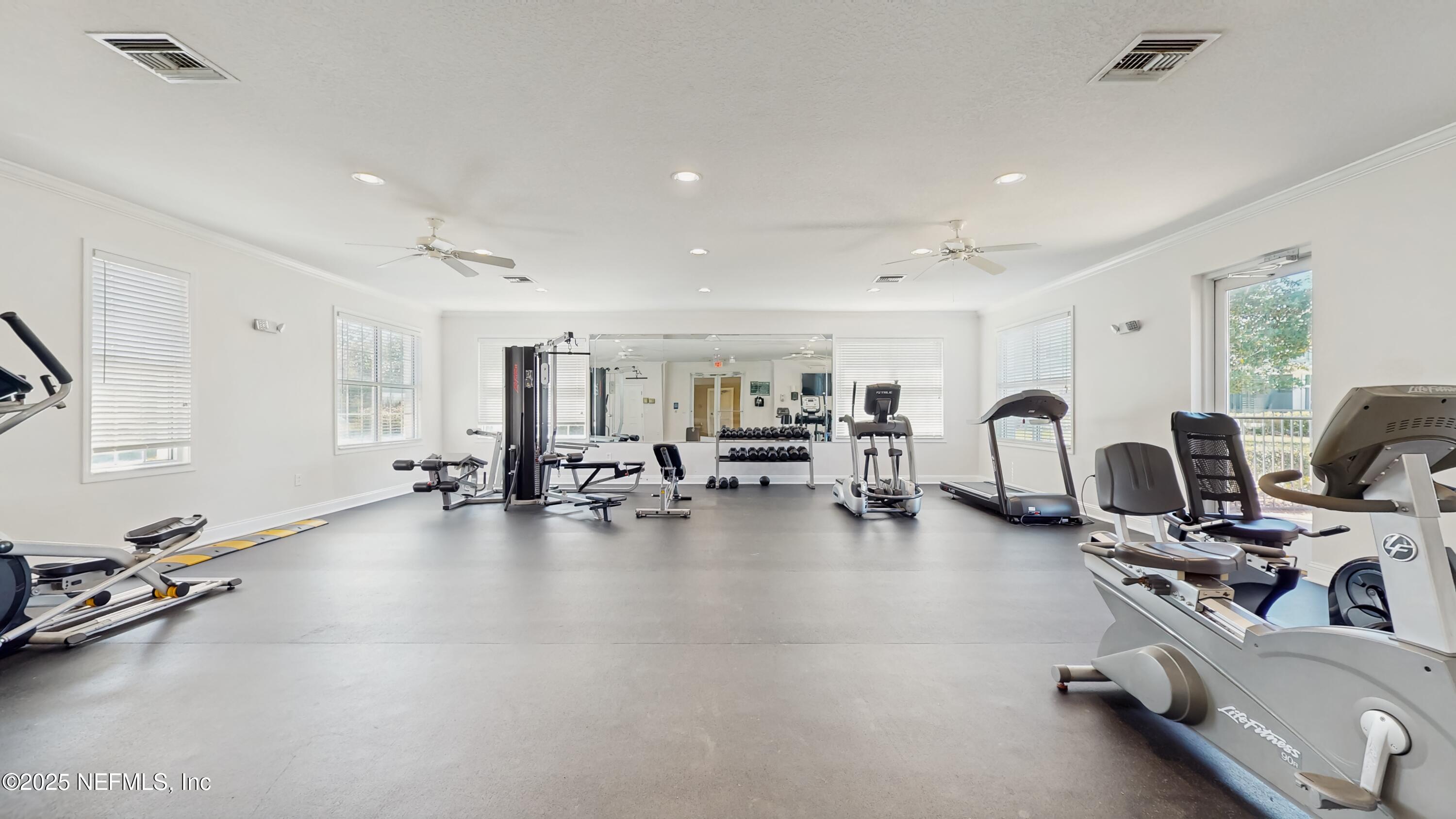 7030 Roundleaf Drive Jacksonville, FL 32258 - Photo 35 of 39 a view of a room with gym equipment and a large window